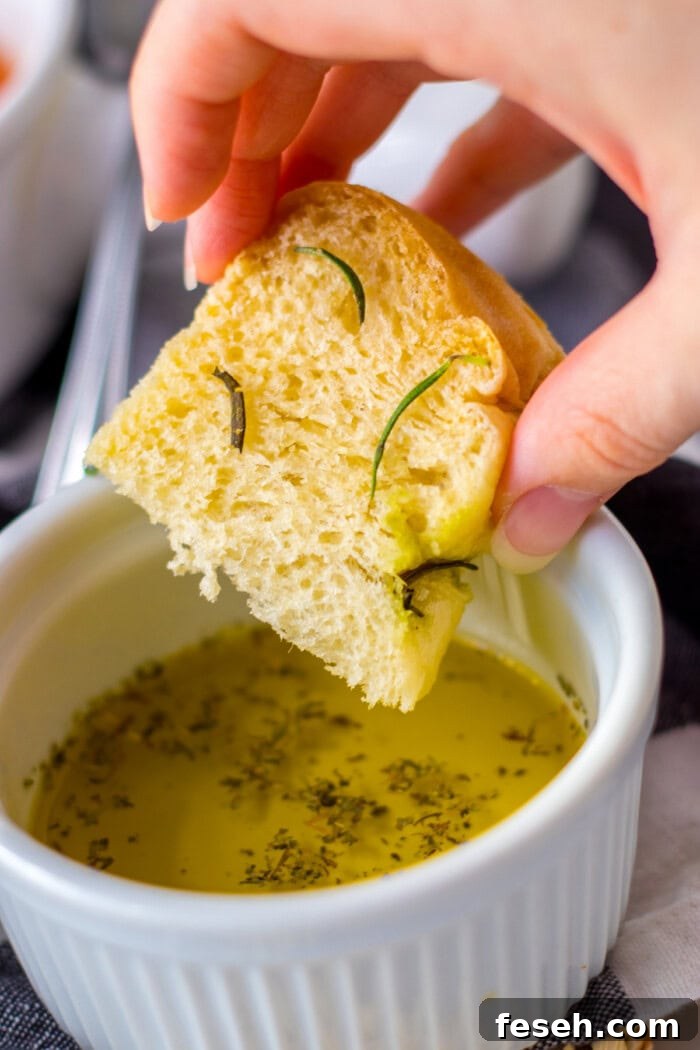 Dipping focaccia bread in olive oil