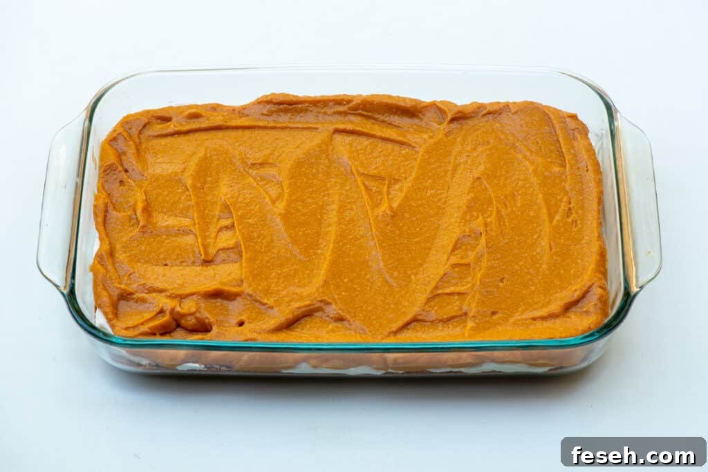 A pumpkin mixture layered in a glass baking dish.