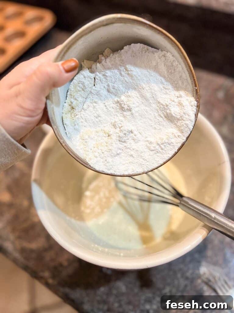Gluten Free Blackberry Muffins step by step instructions flour being poured into bowl