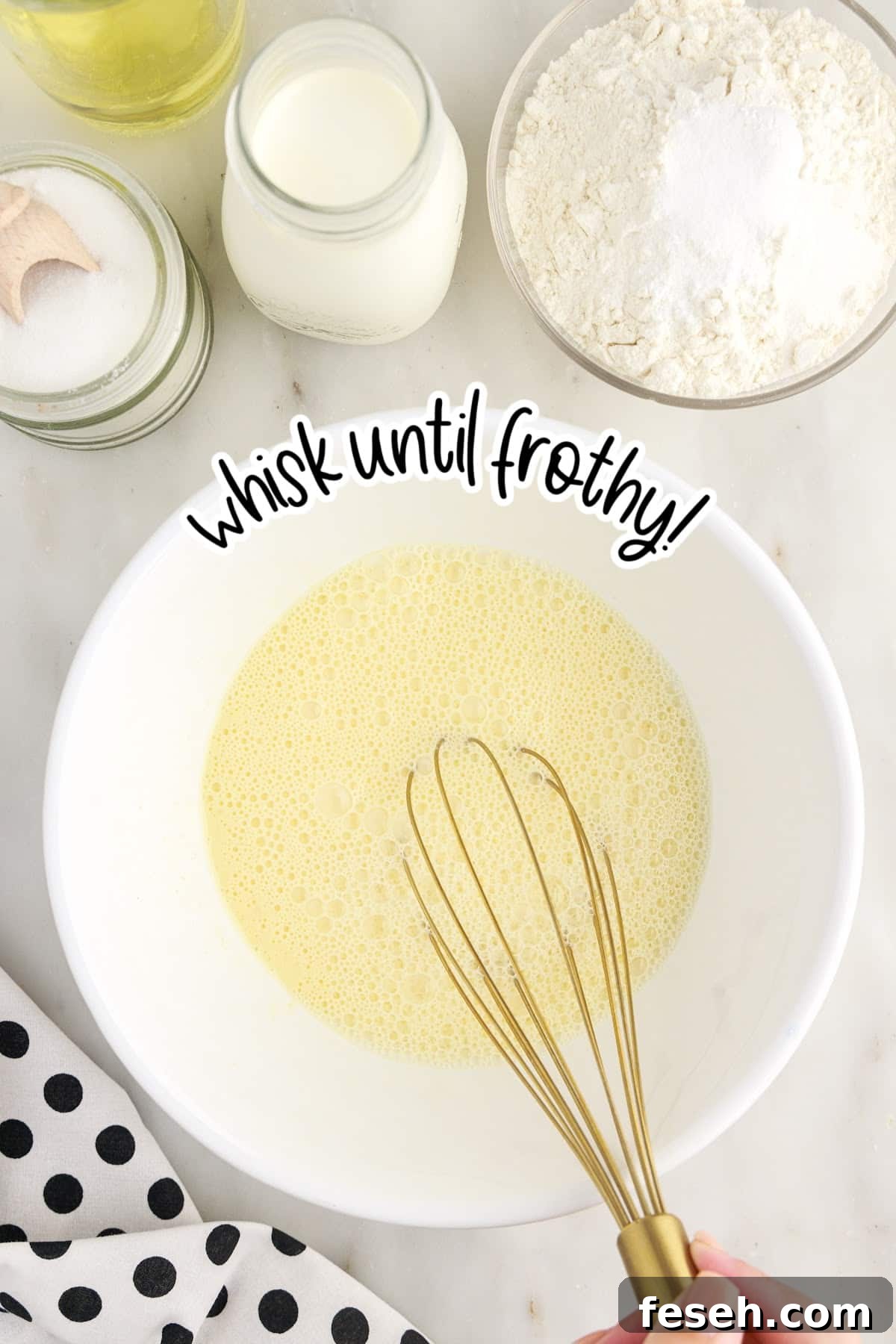 Egg mixed in a mixing bowl with a whisk with text overlay.