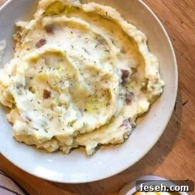A bowl of cheesy garlic mashed potatoes.