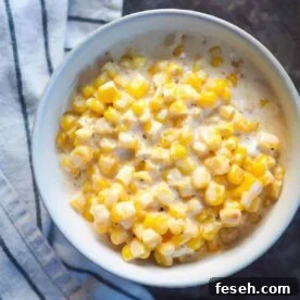 A white bowl of creamed corn.