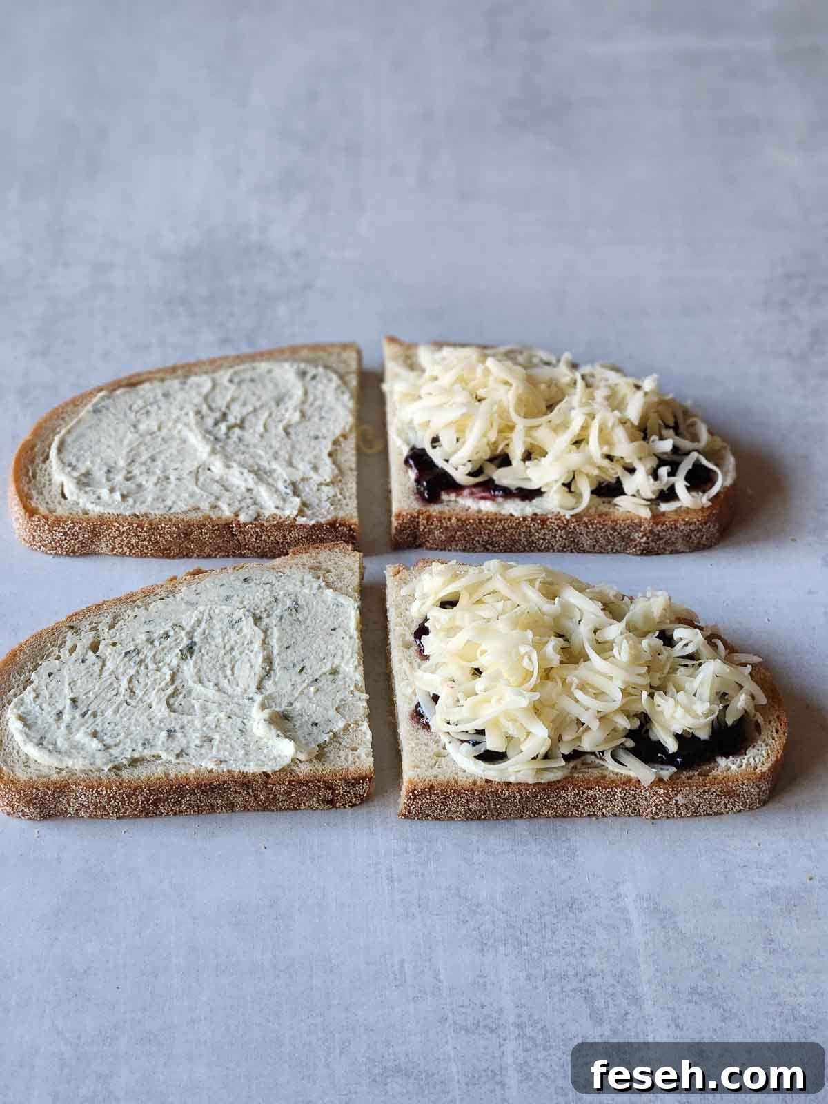 Four slices of bread with ingredients piled on top for grilled cheese.