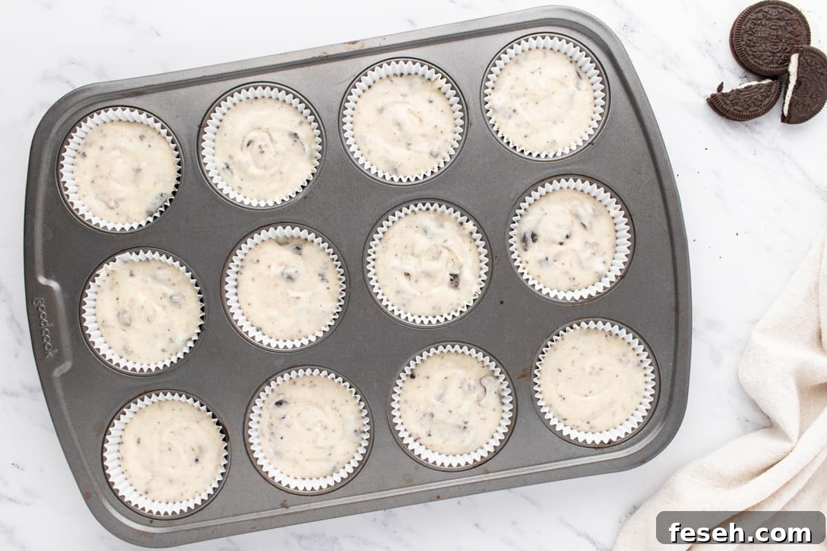 cookies and cream cupcake batter in a cupcake tin before baking.