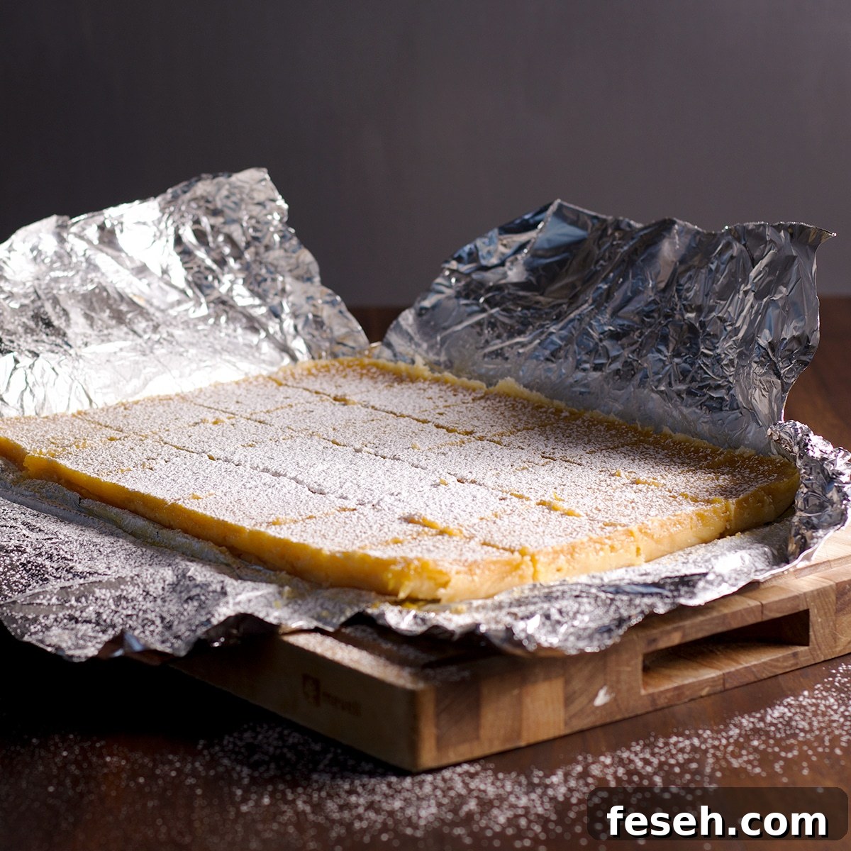 Lemon bars that have been dusted with powdered sugar.