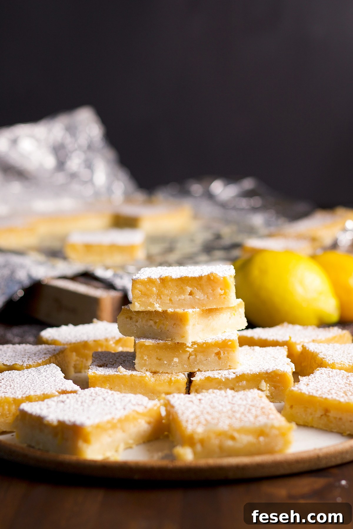 A pile of lemon bars on a serving plate.