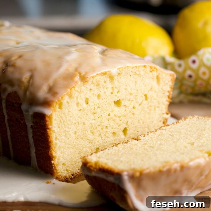 A lemon loaf cake with a few slices cut from the cake.