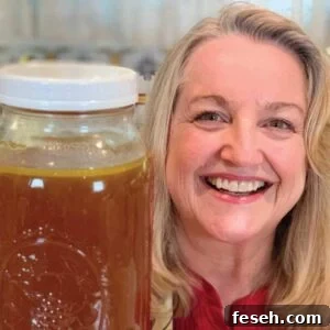 Mary holding a container of fresh turkey bone broth.