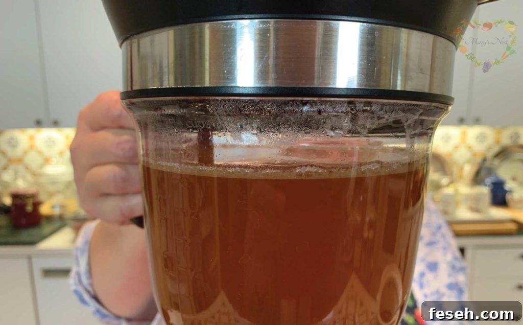 Mary using the Fat Separator device to decant bone broth.