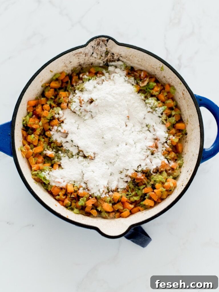 sautéed vegetables in a skillet with flour