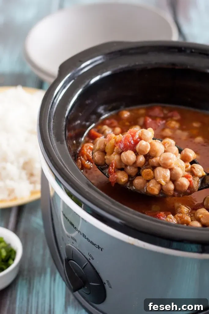This easy slow cooker chickpea curry is a perfect, economical vegetarian dinner recipe! Recipe includes notes for making this in the Instant Pot too. * GoodieGodmother.com