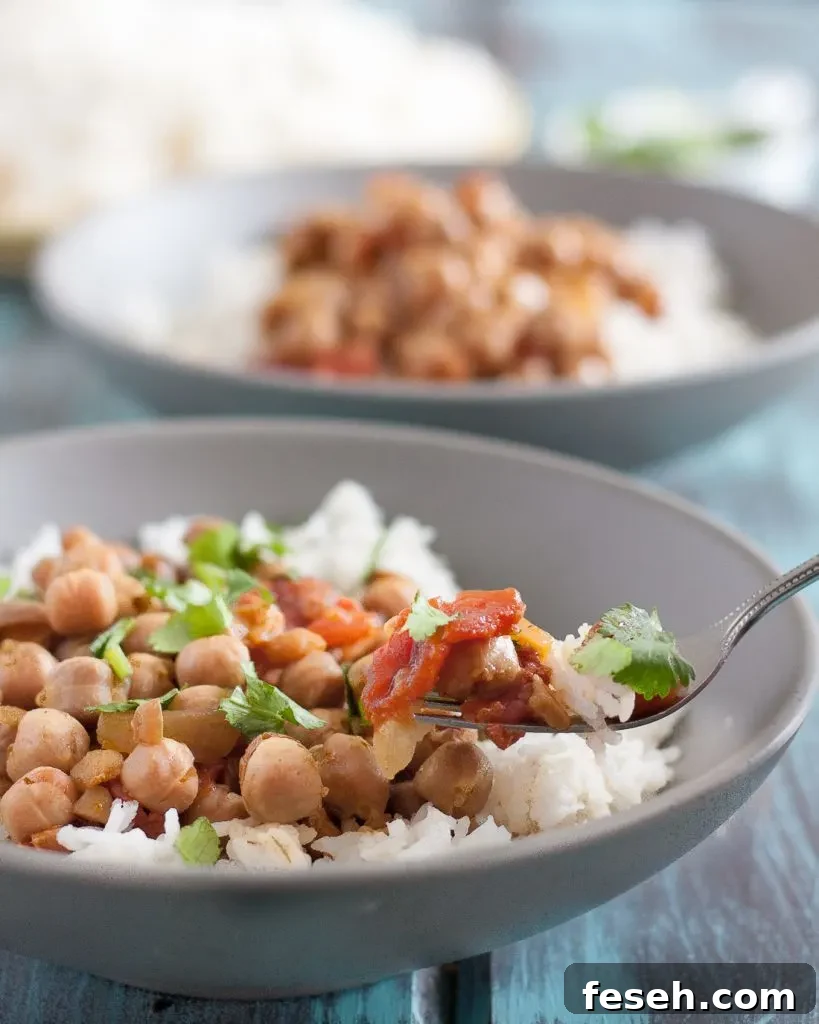 This easy slow cooker chickpea curry is a perfect, economical vegetarian dinner recipe! Recipe includes notes for making this in the Instant Pot too. * GoodieGodmother.com