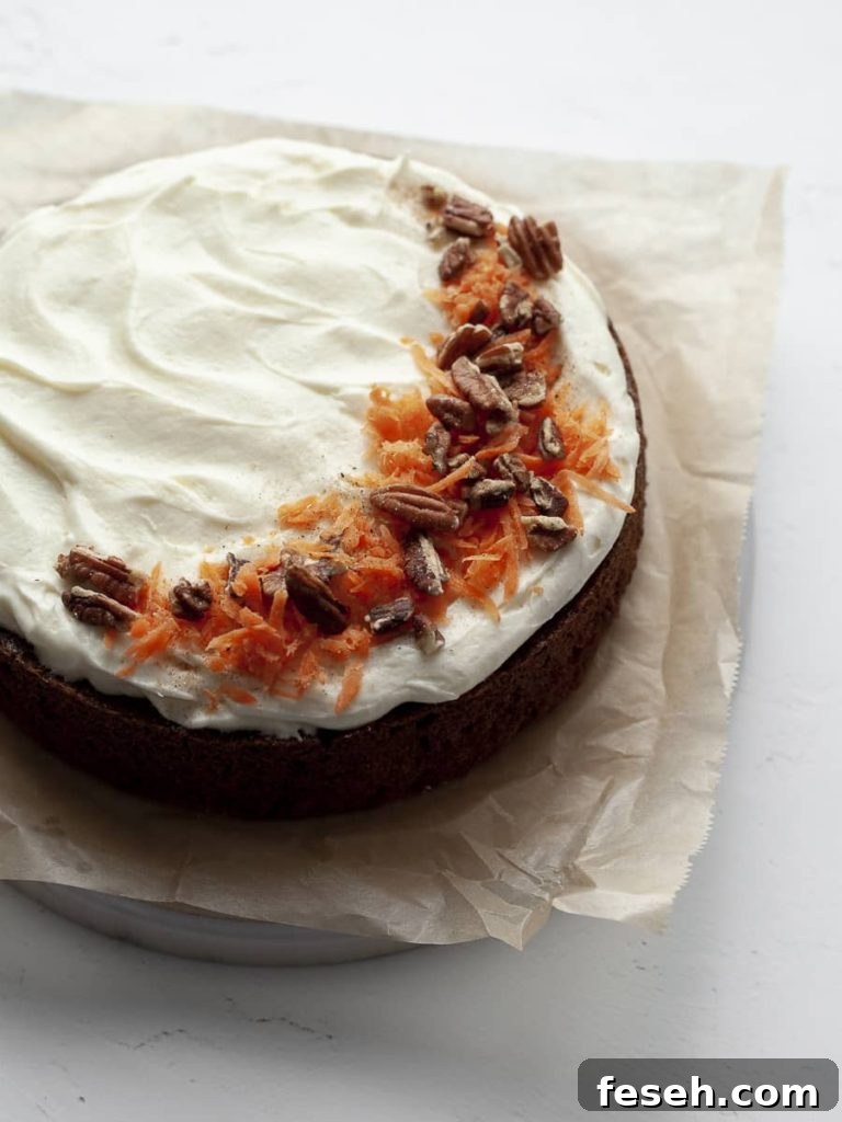 SIngle Layer Gluten Free Carrot Cake topped with cream cheese frosting, carrots and pecans