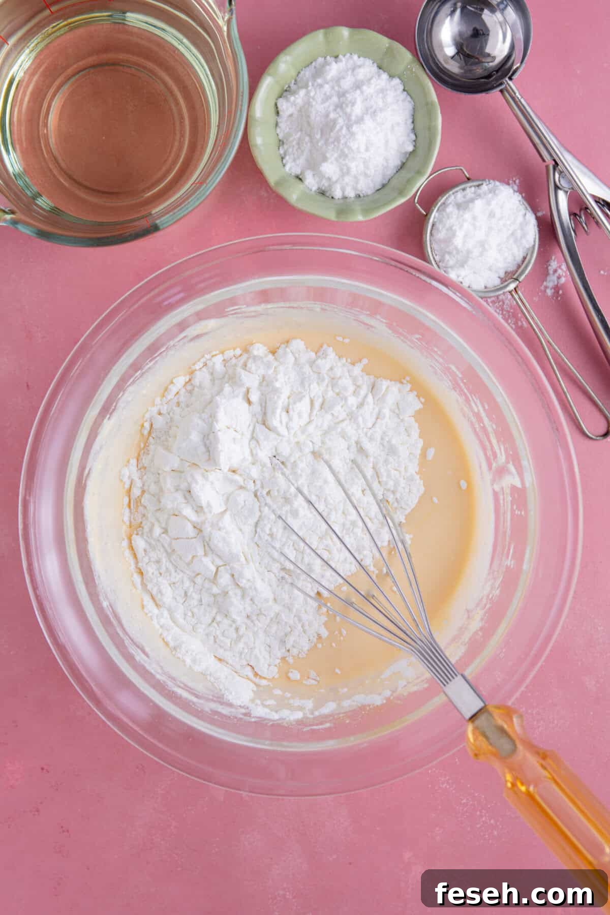 Process shot for gluten free zeppole showing the dry ingredients added to the wet ingredients.