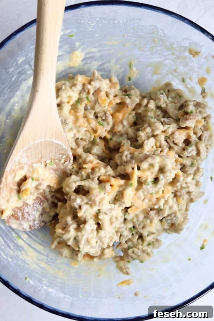Sausage egg muffin batter mixed in a large glass bowl