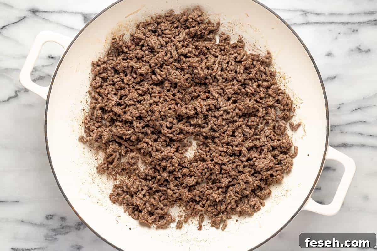 Large pan filled with ground beef. 