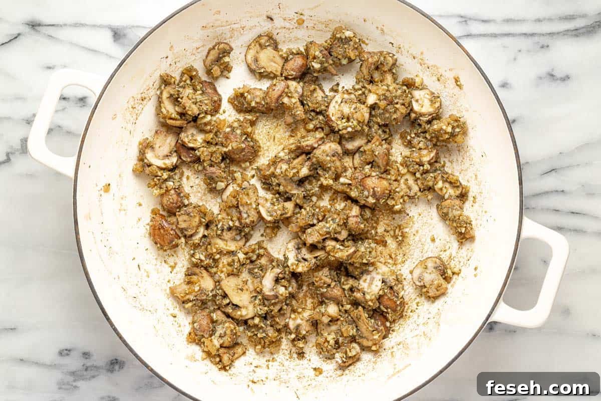 Sauteed mushrooms and onions in a large pan. 