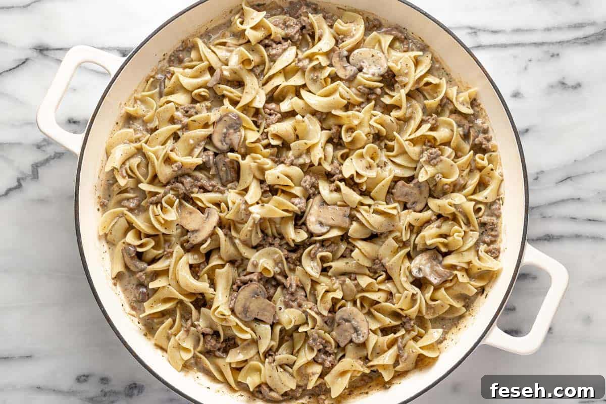 Homemade ground beef stroganoff with egg noodles in a large pan. 