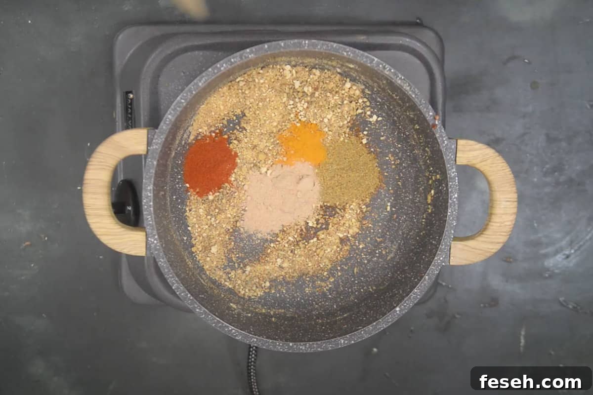 Dry spice powders added in the pan.