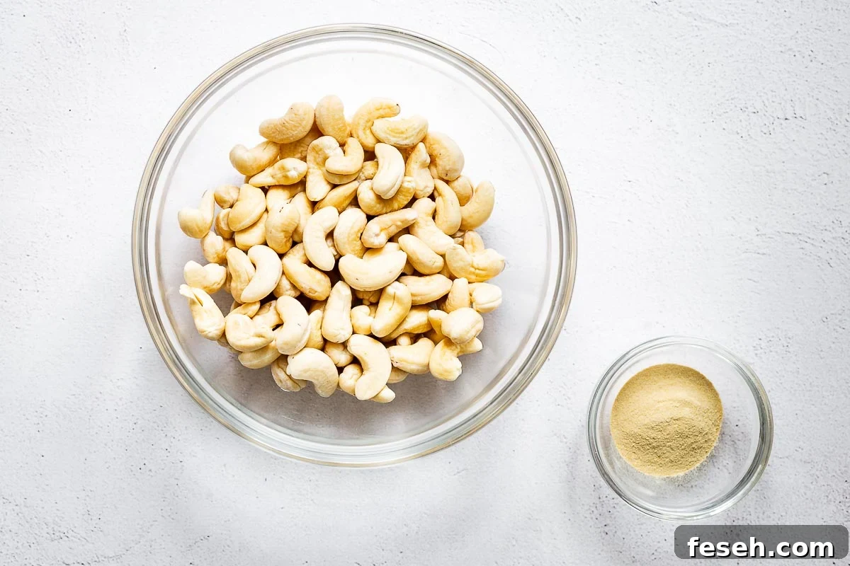 12 Great Pine Nut Substitutes for Pesto You’ll Love 4 Soaked cashew nuts in a bowl next to a smaller glass bowl of nutritional yeast powder.