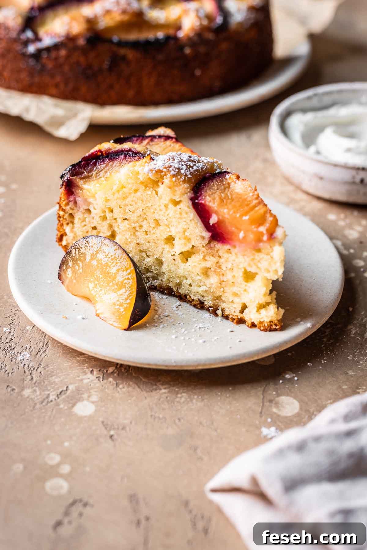 A slice of plum cake on a plate.