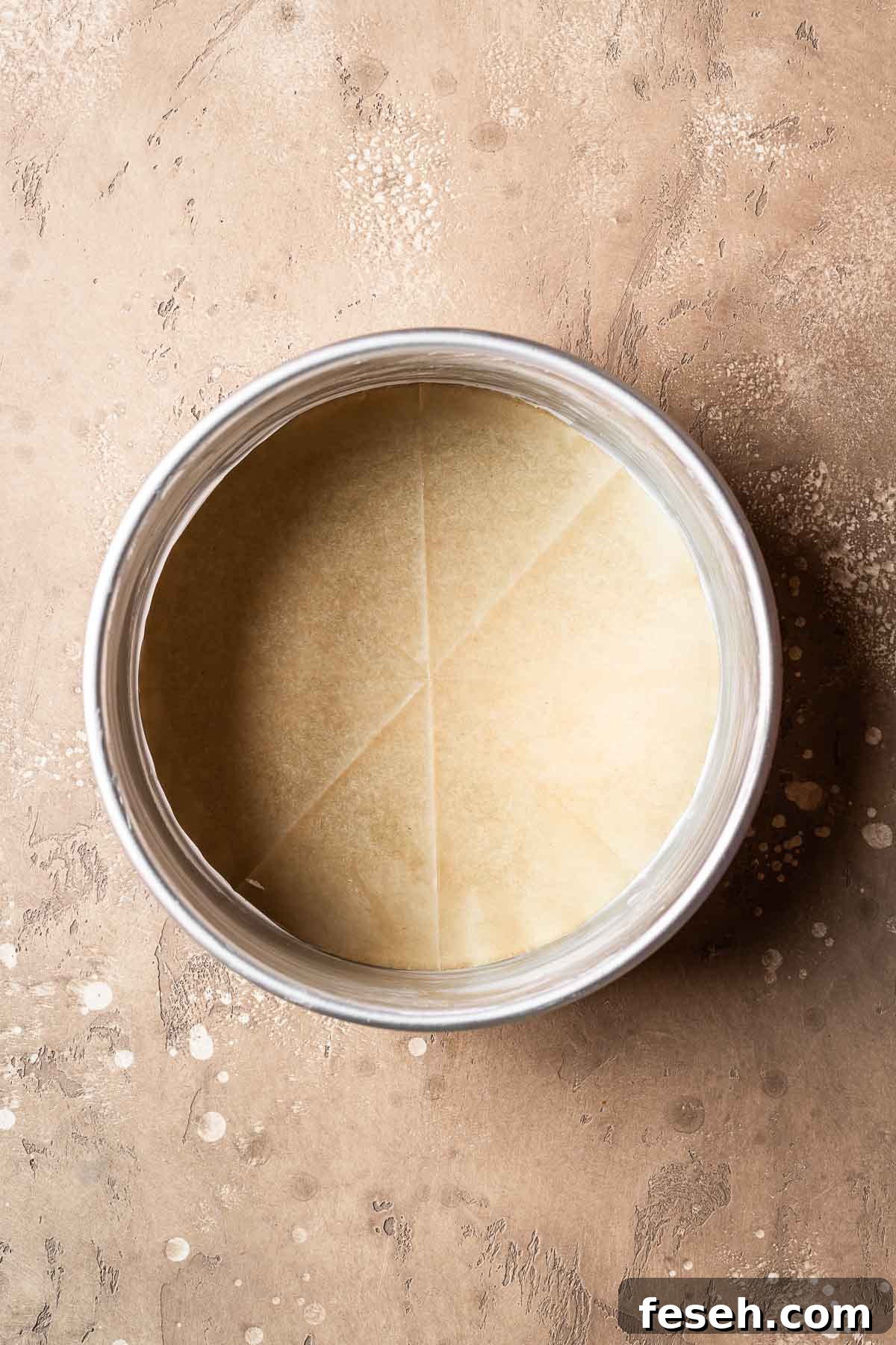 A greased and parchment lined 8 inch cake pan.