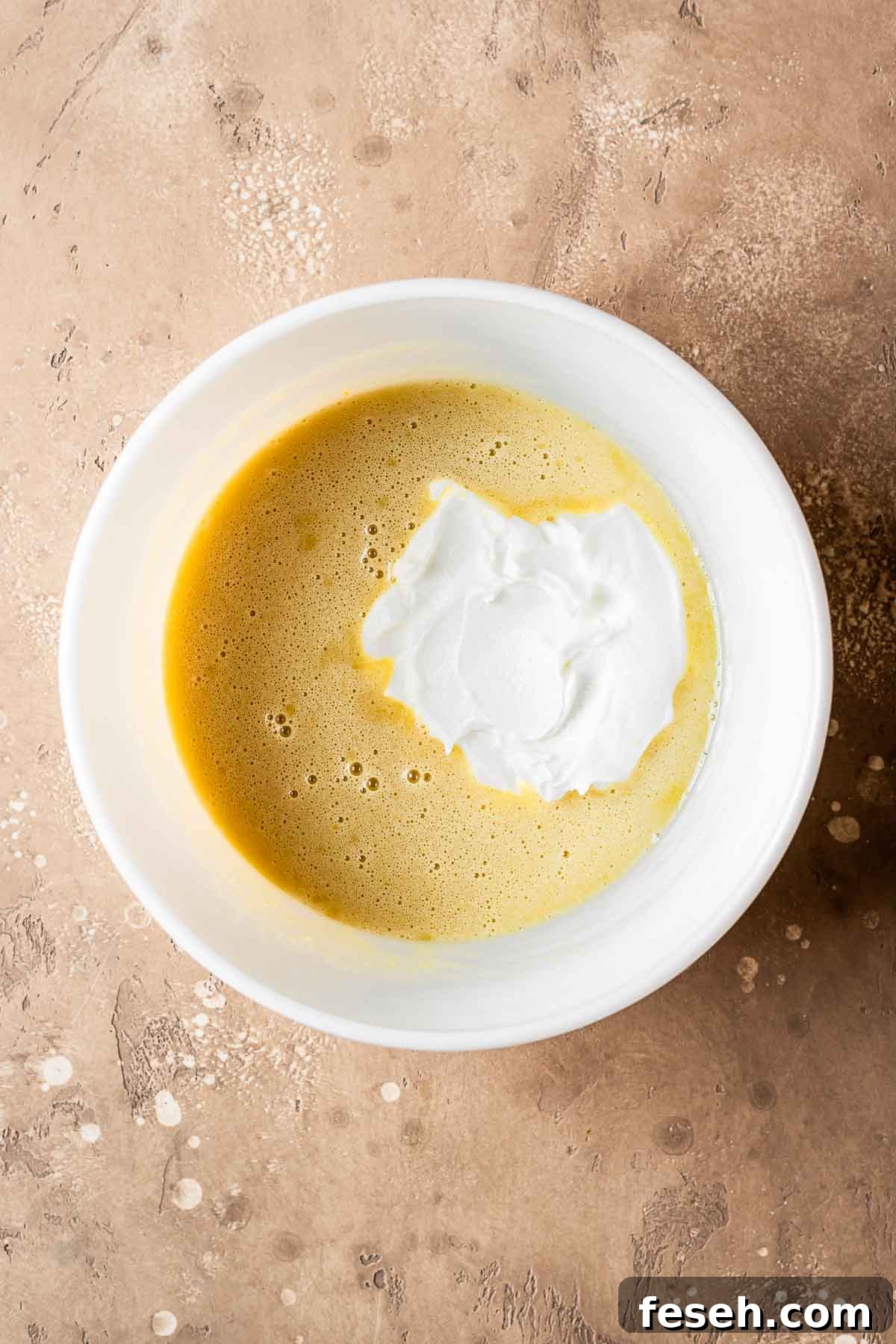 A ceramic bowl of wet ingredients plus yogurt.