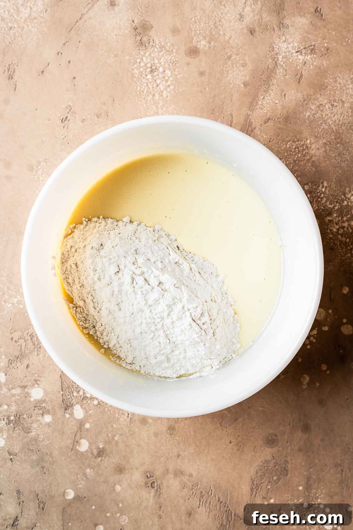 Wet ingredients fully mixed together with dry ingredients added.