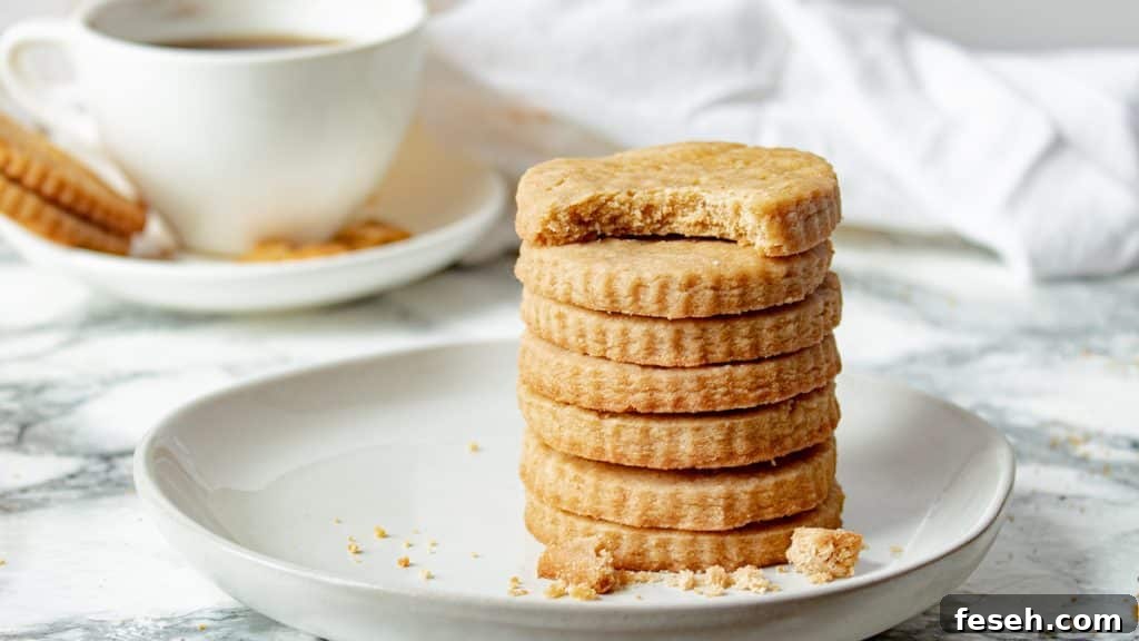 stack of brown sugar shortbread cookies with a cup of coffee in the background