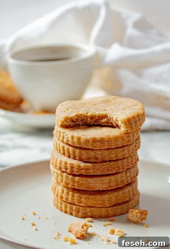 stack of brown sugar shortbread cookies with a cup of coffee in the background