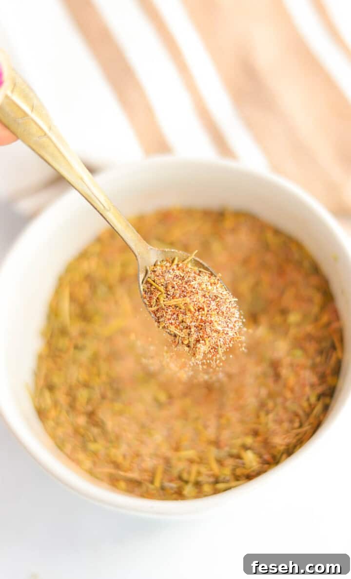 Turkey Seasoning being spooned out of a white bowl.