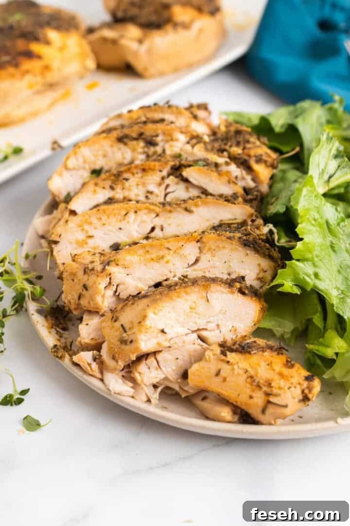 sliced turkey breast on white plate with salad.