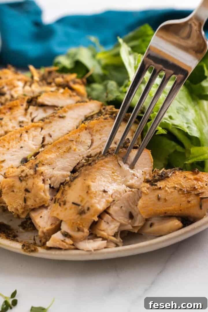 using fork to grab sliced turkey breast.