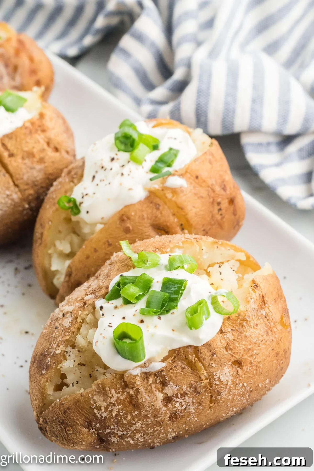 Smoked baked potatoes topped with sour cream and chives
