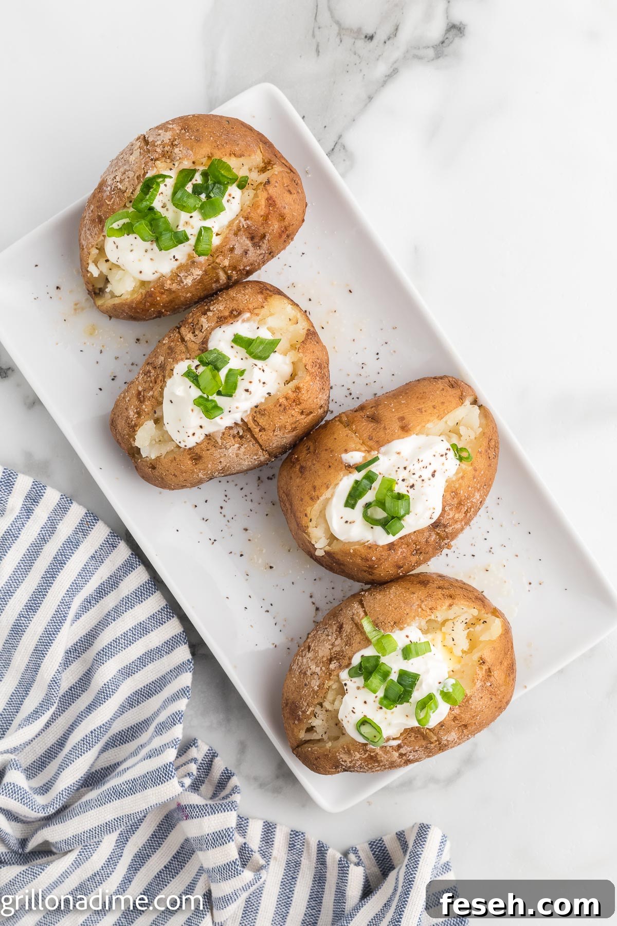 Smoked baked potato topped with sour cream and chives