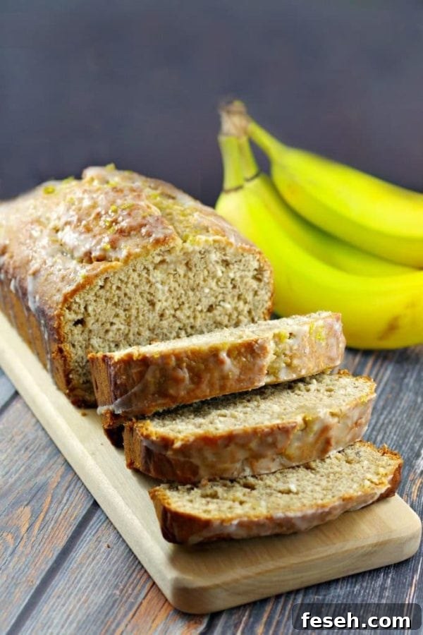 a sliced loaf of tropical banana bread on a wood platter on a wood table