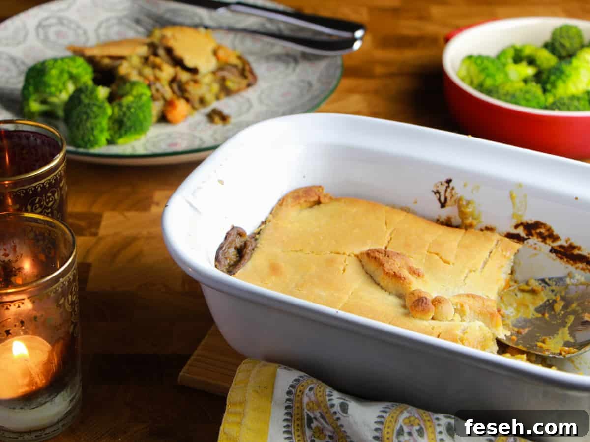 Photo showing Creamy Vegan Pot Pie in an oven dish with a portioned on a plate in the background and a bowl of broccli