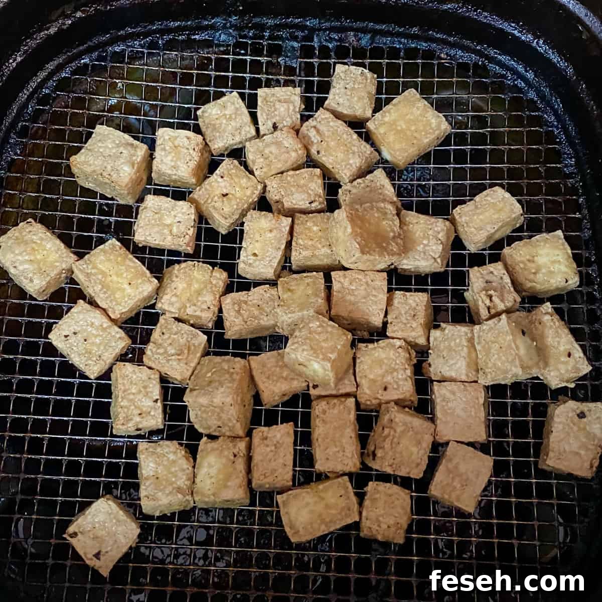 photo of tofu cubes cooking in the air fryer