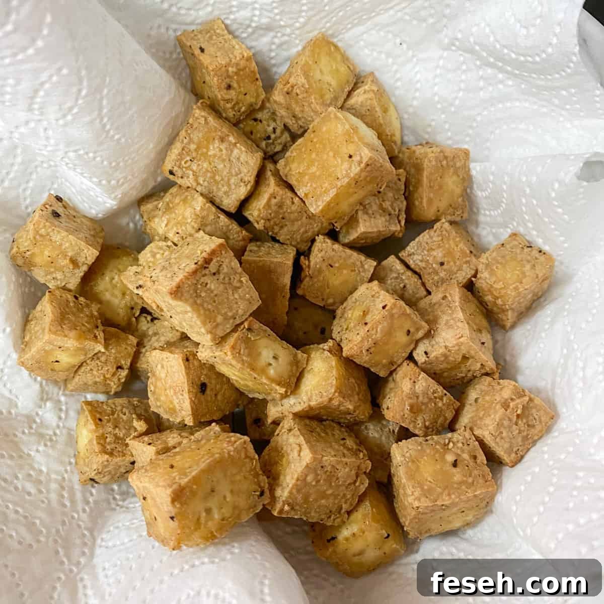 Photo of cooked tofu cubes on a kitchen towel.