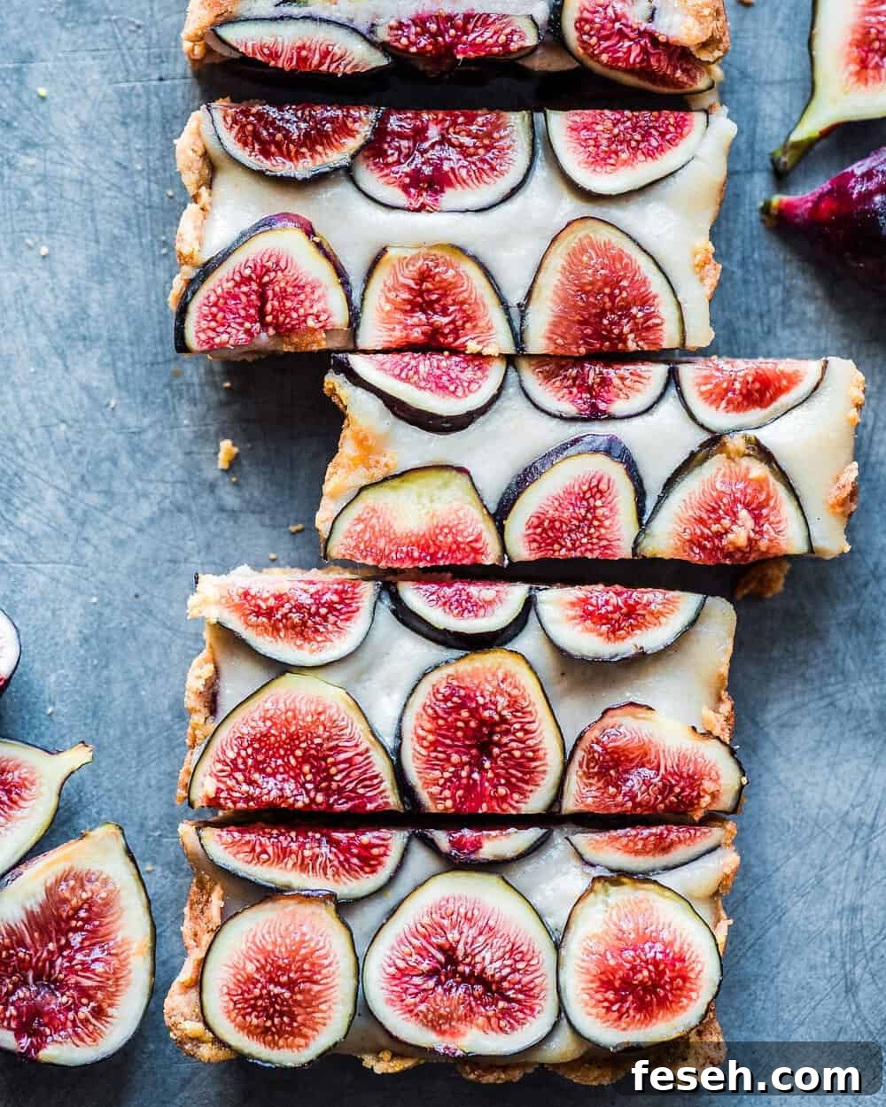Cut fig tart slices on blue-grey table.