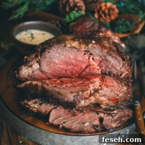 Perfect Grilled Prime Rib Recipe for Juicy, Flavorful Results 12 A roast on a plate with a sauce on it.