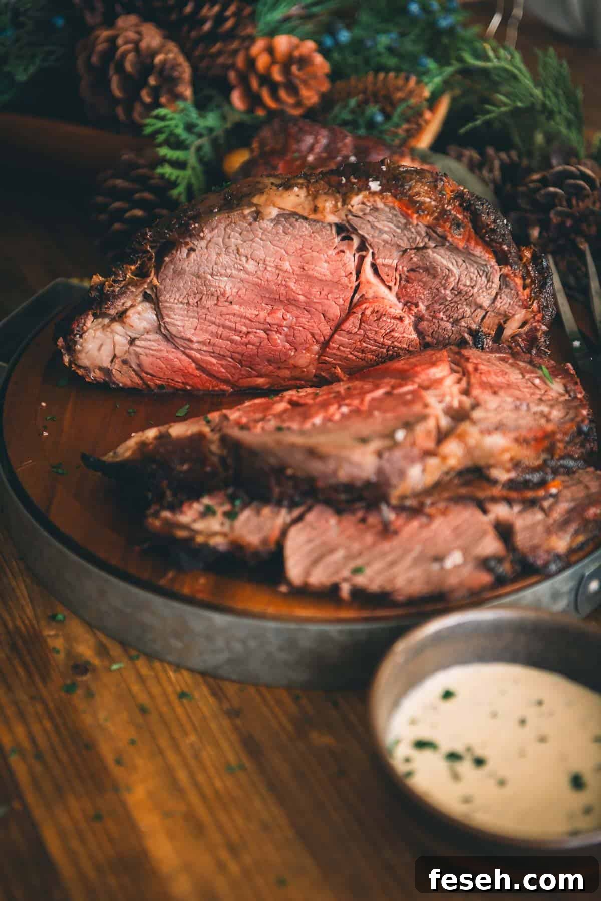 Perfect Grilled Prime Rib Recipe for Juicy, Flavorful Results 10 A standing rib roast with sauce and pine cones on a wooden table.