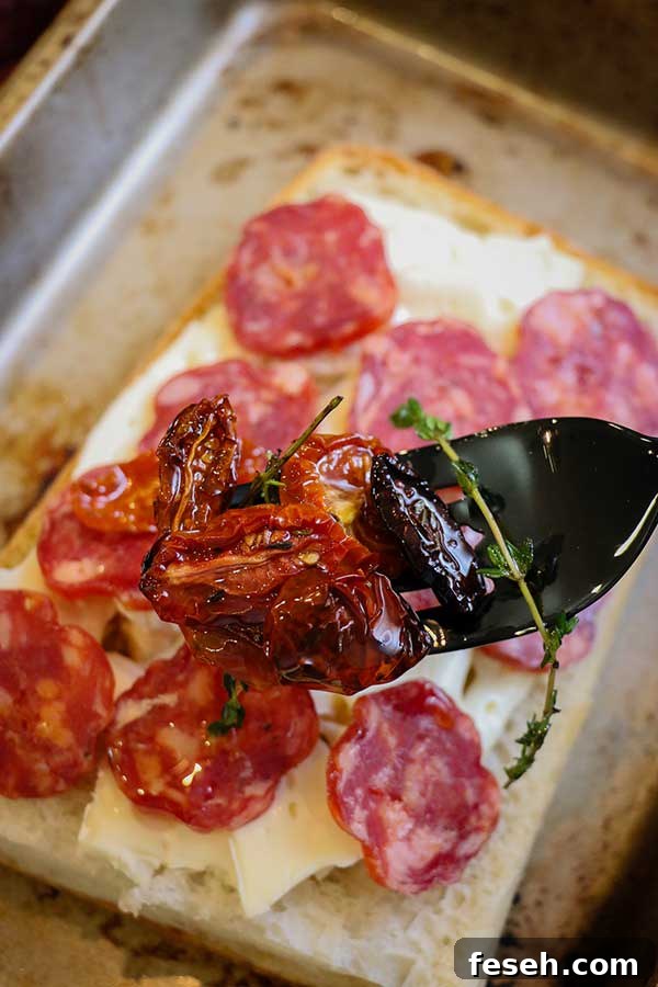 brie and spicy salami on ciabatta placed on baking dish