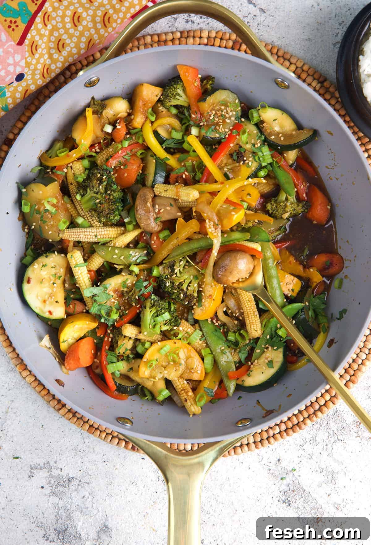Homemade Vegetable Stir Fry in a wok with a serving spoon.