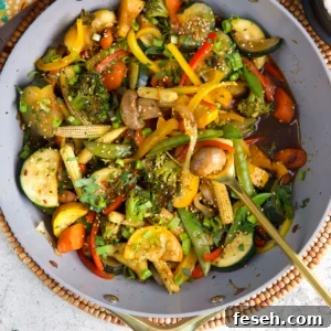 Homemade Vegetable Stir Fry in a wok with a serving spoon.