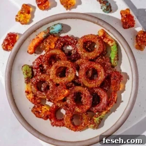 candies coated in tajin seasoning and chamoy sauce.