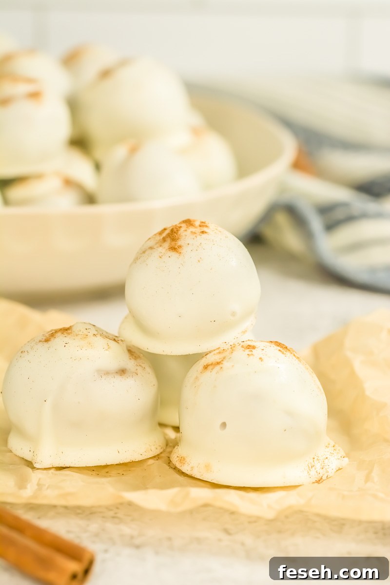 Pumpkin cream cheese balls on parchment paper.