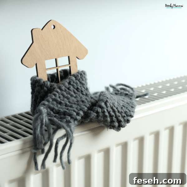 A wooden house ornament wrapped in a gray knitted scarf sits on a white home radiator, symbolizing energy-efficient heating.