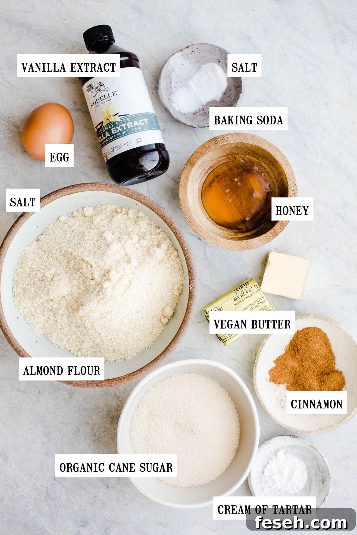 Ingredients for snickerdoodle cookies on a light blue surface.