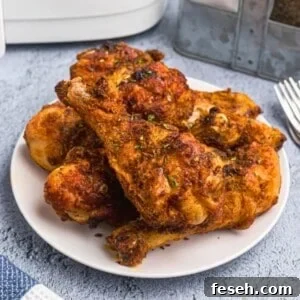 Juicy crusted chicken with seasonings served on a white plate